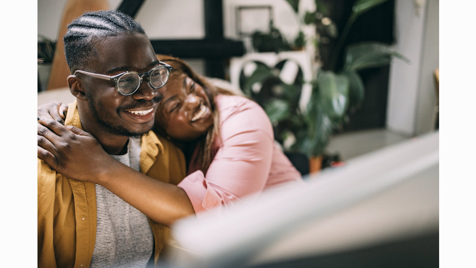  A happy couple - a woman rests her head on her partner's shoulder
