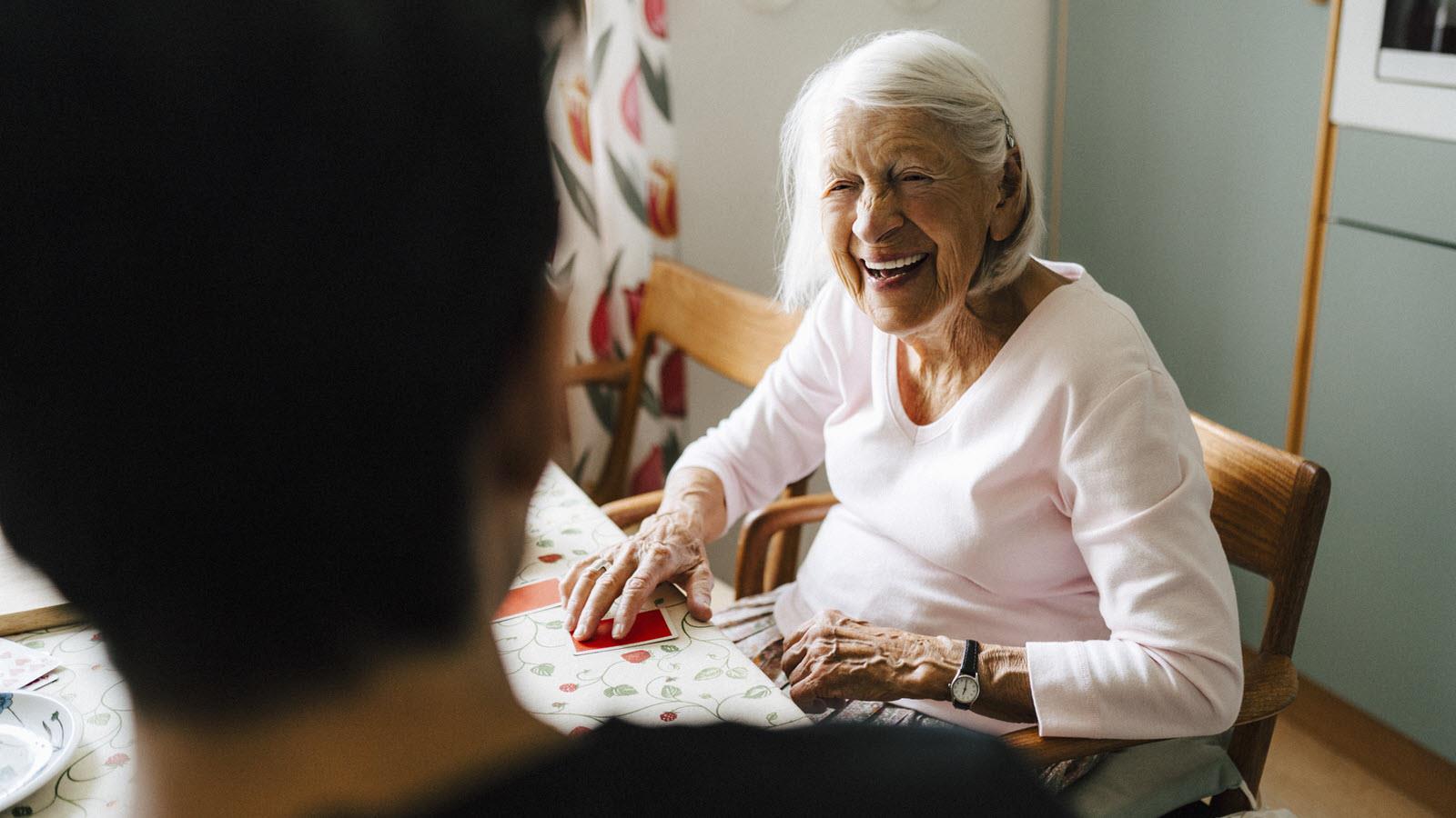 Elderly patient smiles at caregiver