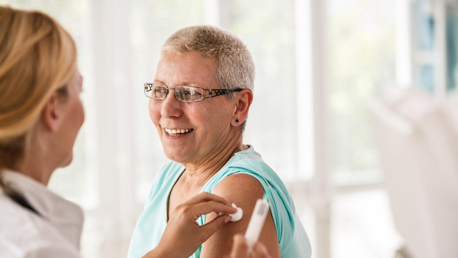 A senior citizen gets a flu immunization