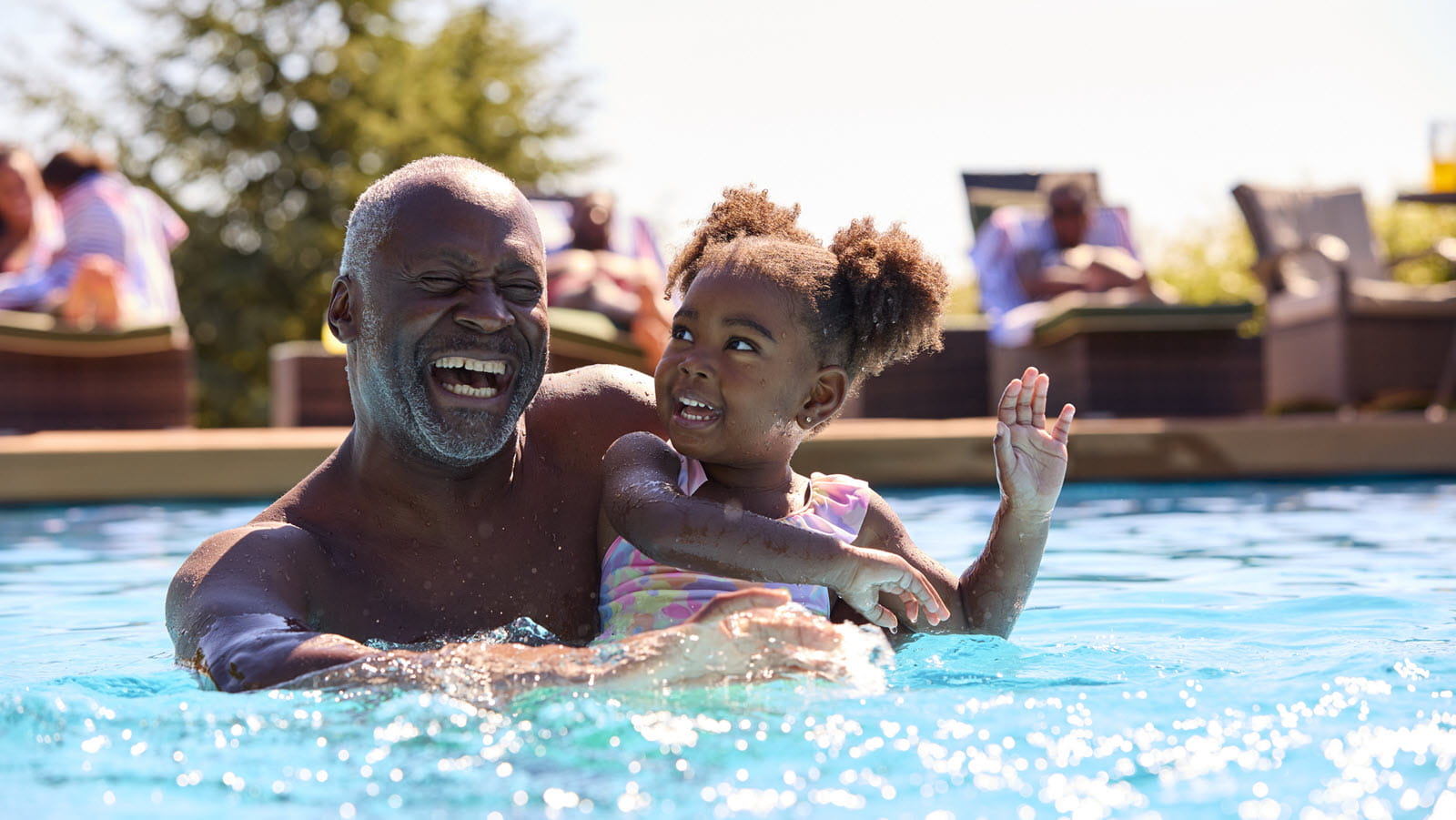 Grandfather and child in swimming pool