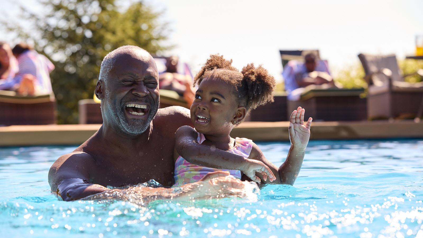 Grandfather and child in swimming pool