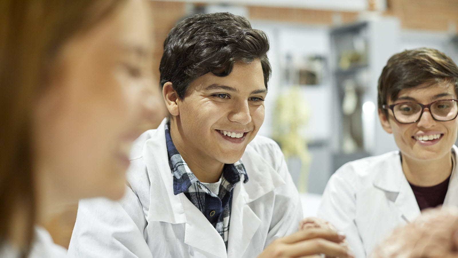 Three young medical students in white coats