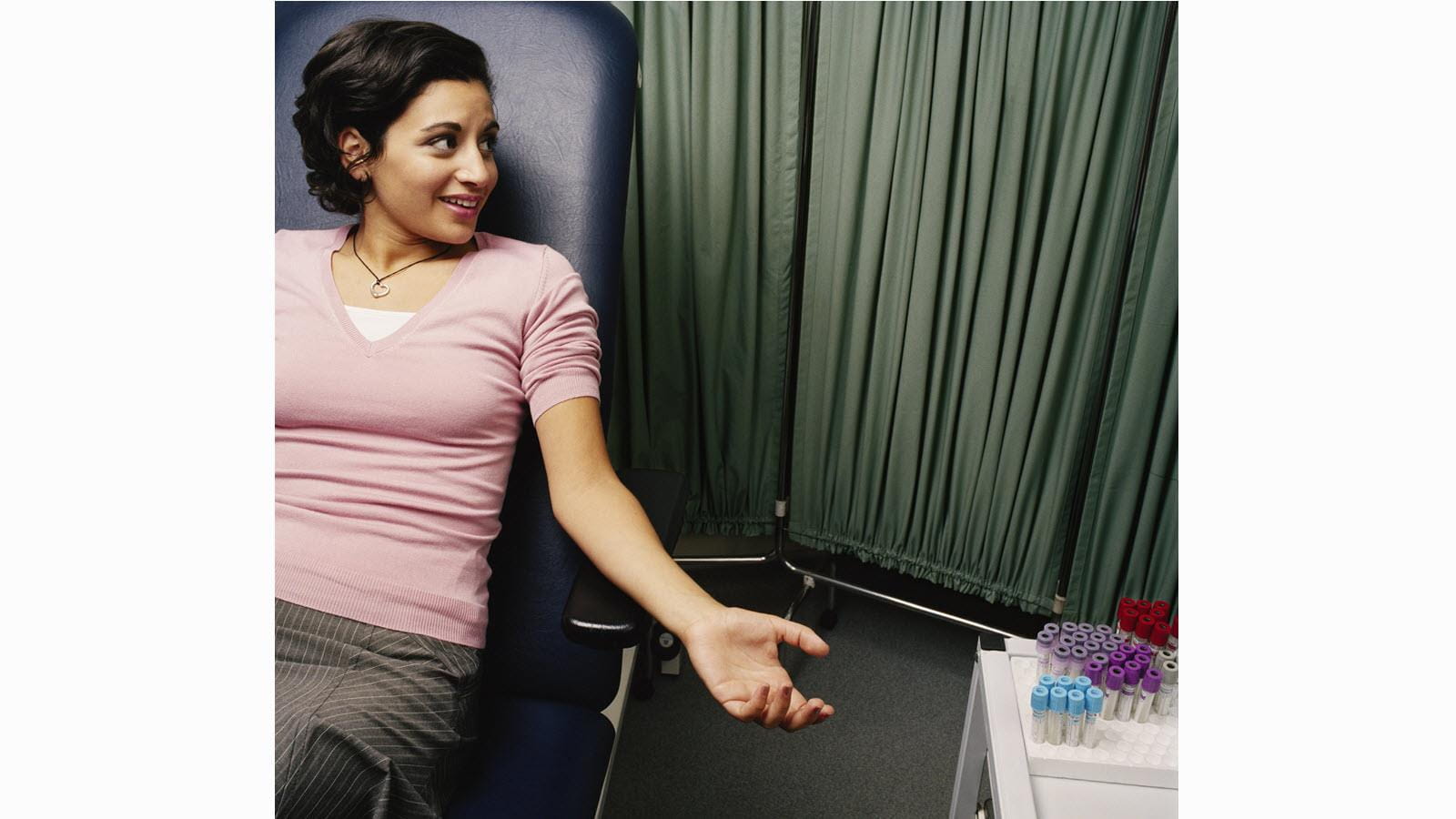 A woman prepares to give a blood sample