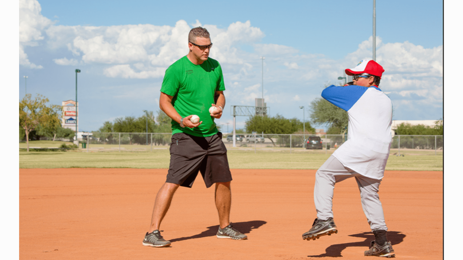 Coach Jesse Schrader works with a young baseball player at the CSL Behring Gettin' In the Game Junior National Championship.