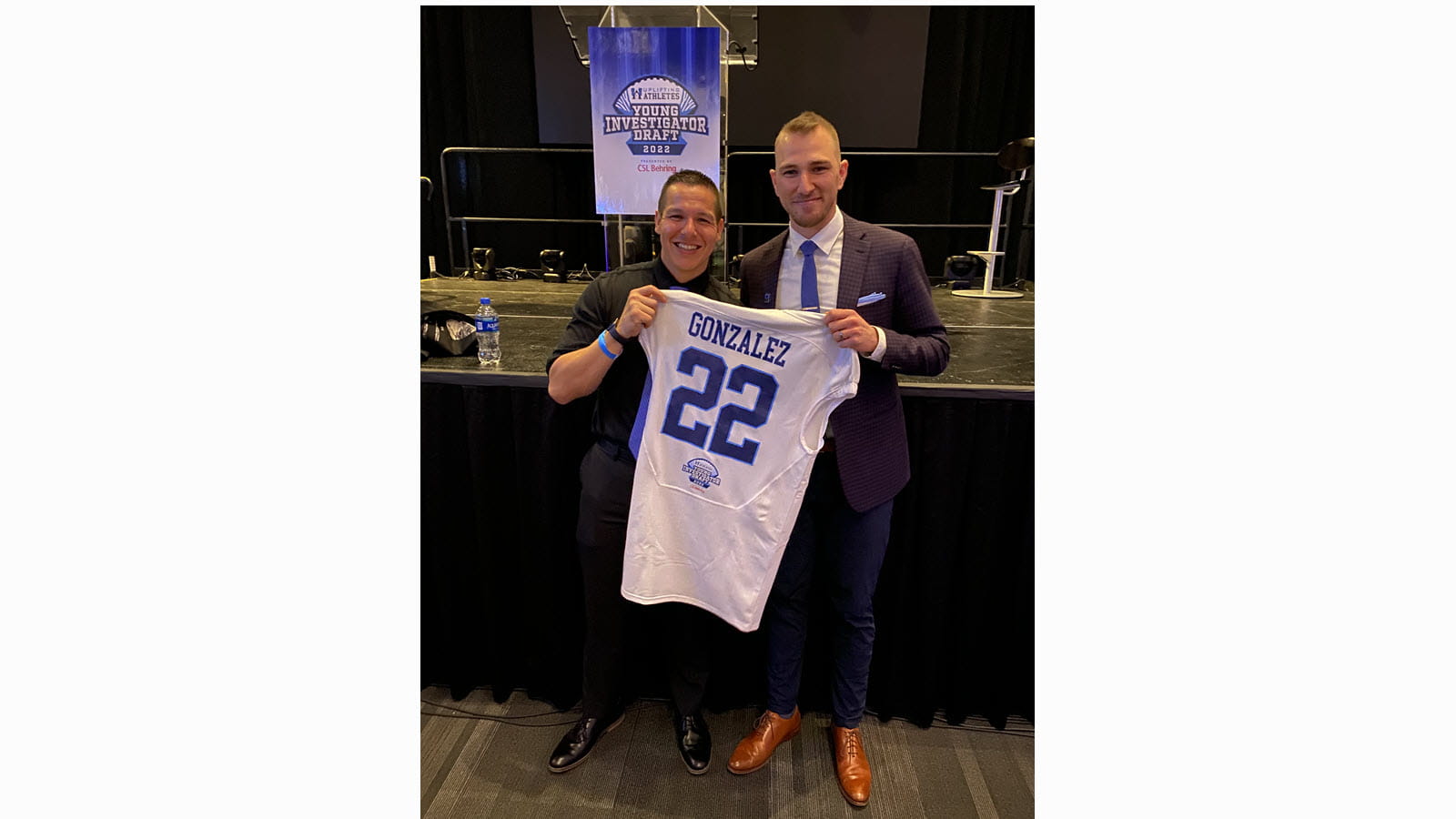 Researcher Michael Gonzales celebrates with Uplifting Athletes' Rob Long.