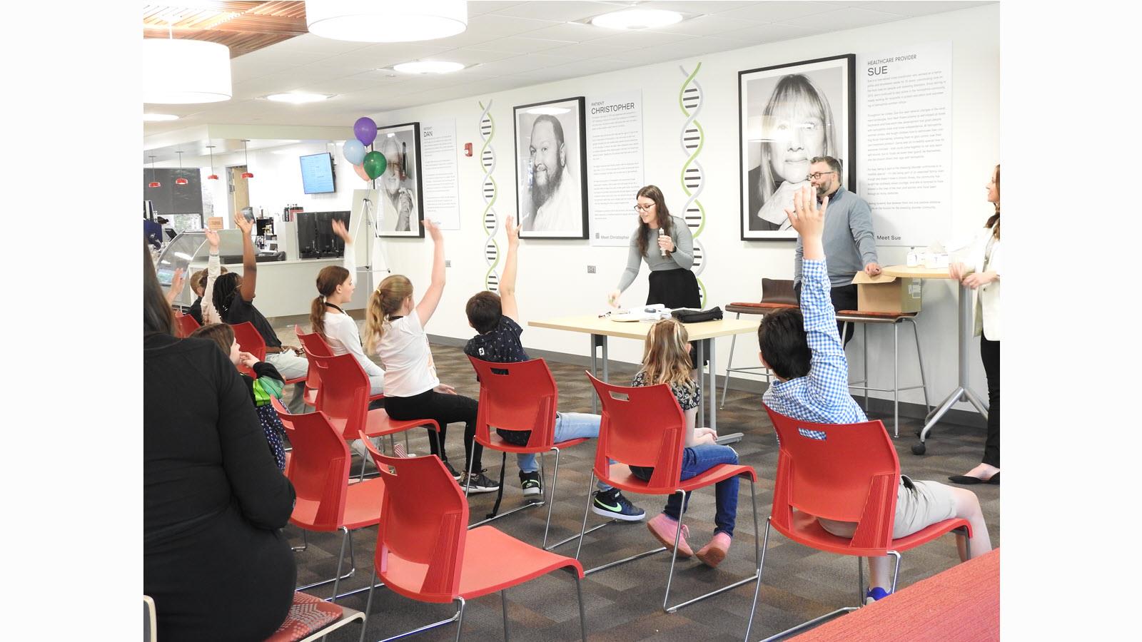 Hands go up during a session at Take Our Daughters and Sons to Work Day in King of Prussia, Pennsylvania.