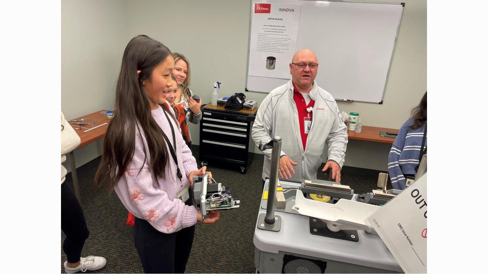 Young visitors get an up-close look at equipment during Take Our Daughters and Sons to Work Day.