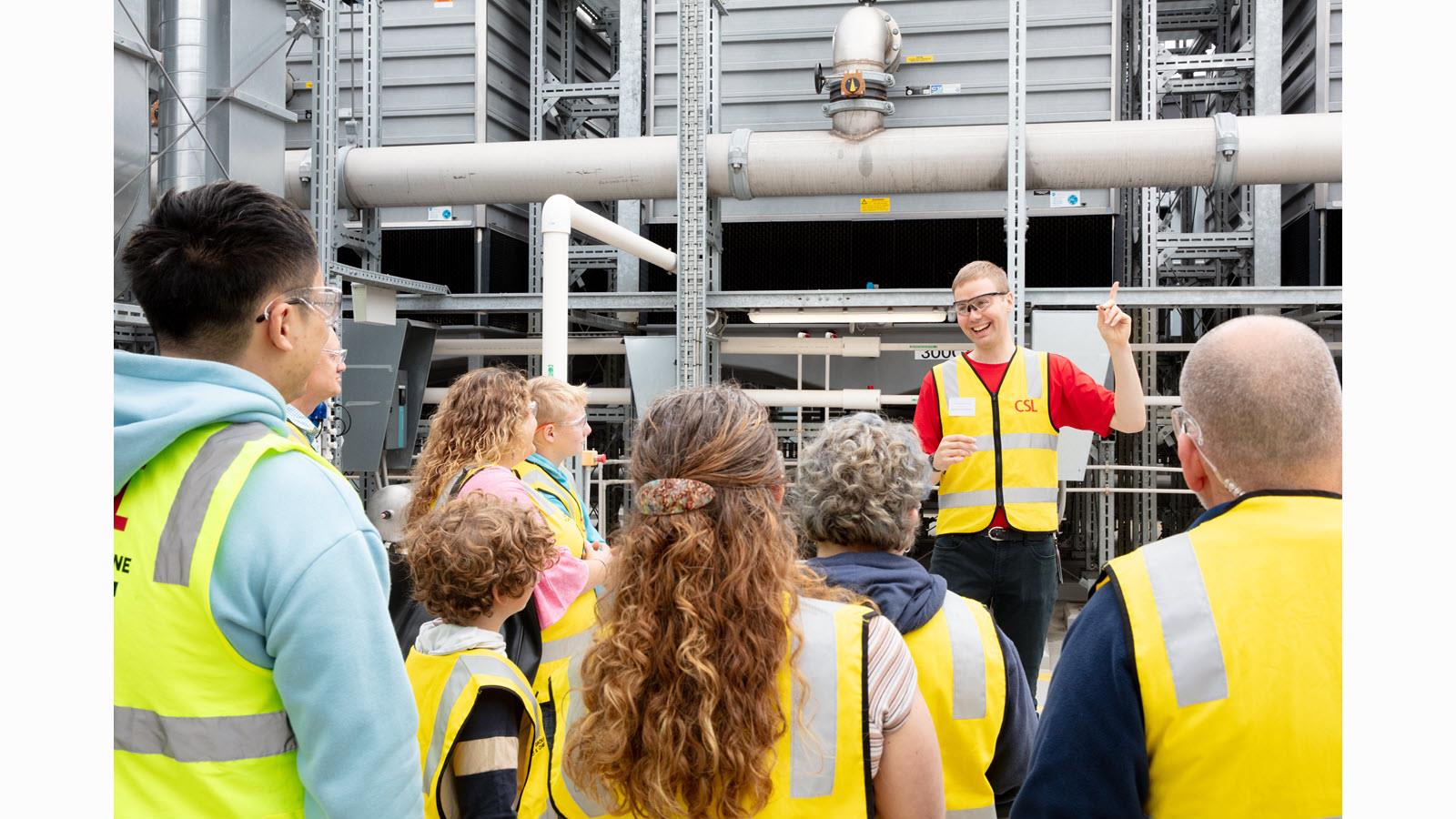 A tour group looks at exterior facilities at CSL during Friends & Family Day.