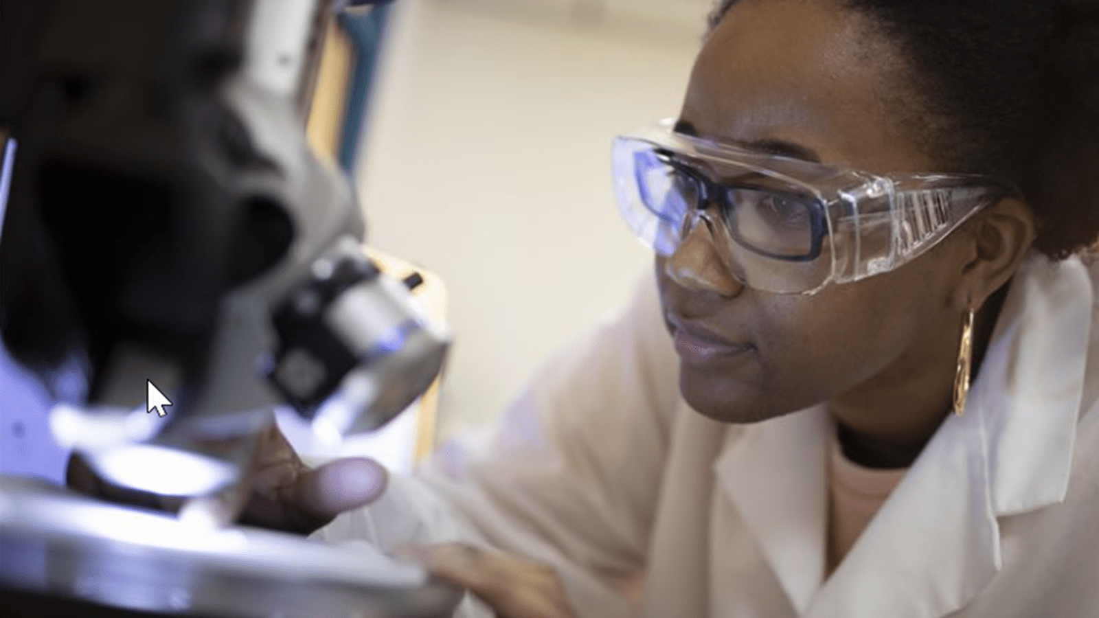Researcher looks into a microscope