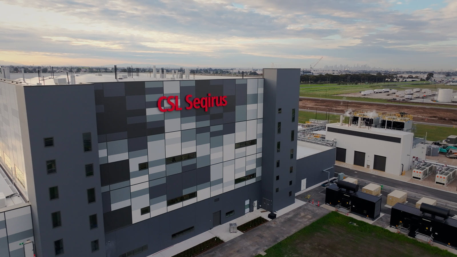 CSL Seqirus's Tullamarine manufacturing facility with city skyline in the distance