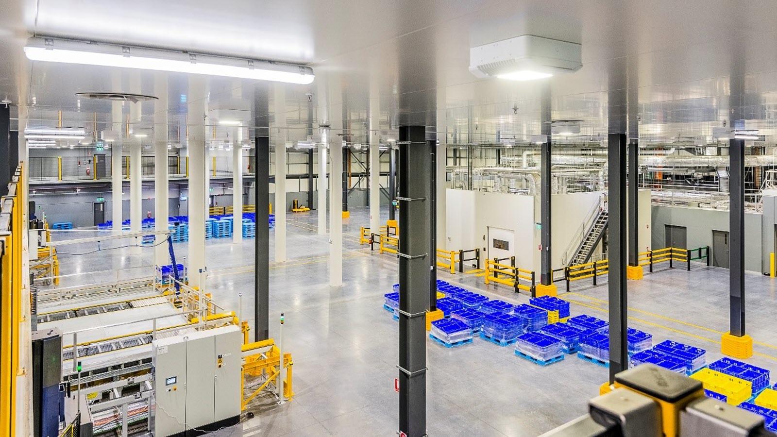 A fully automated warehouse uses robotic vehicles to manage materials, further streamlining operations.