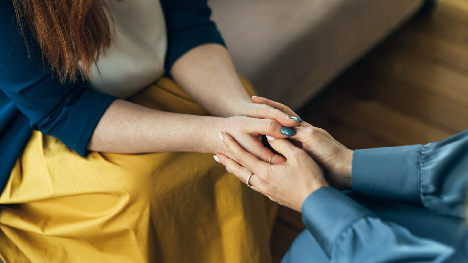 Caregiver and patient holding hands