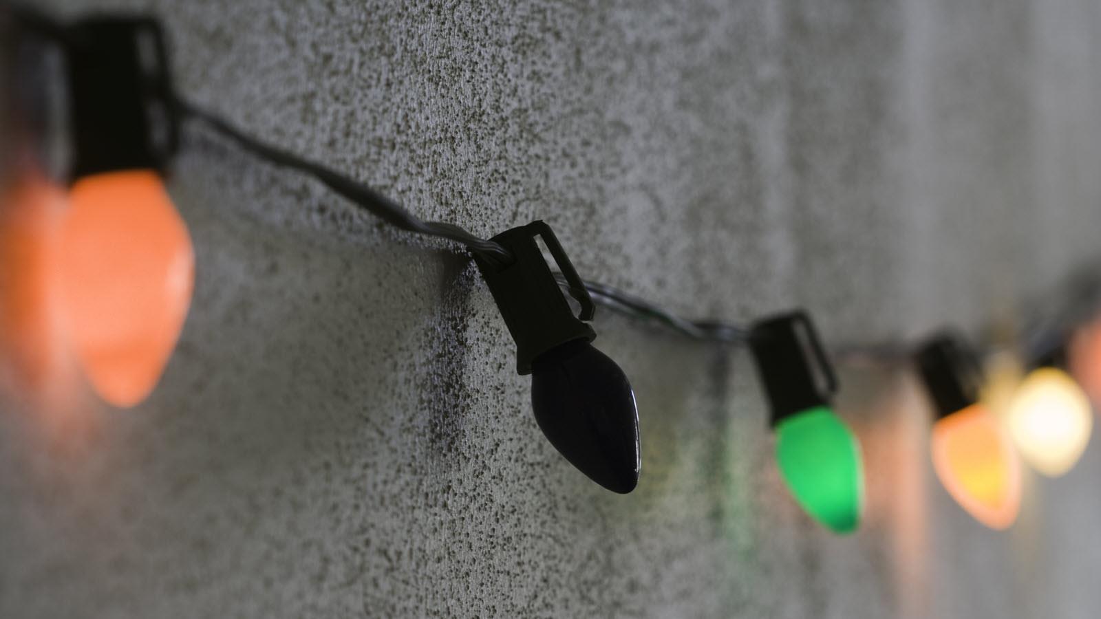 A string of holiday lights with one burned-out bulb